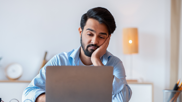 Corporate employee practicing mindfulness at the workplace to reduce stress and improve mental well-being.